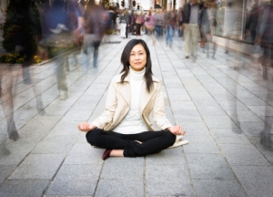 asian-woman-meditate-on-busy-street